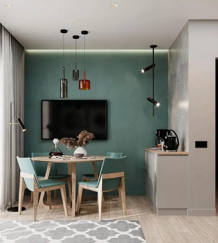 Дизайн кухни-гостиной с диваном и телевизором на стене