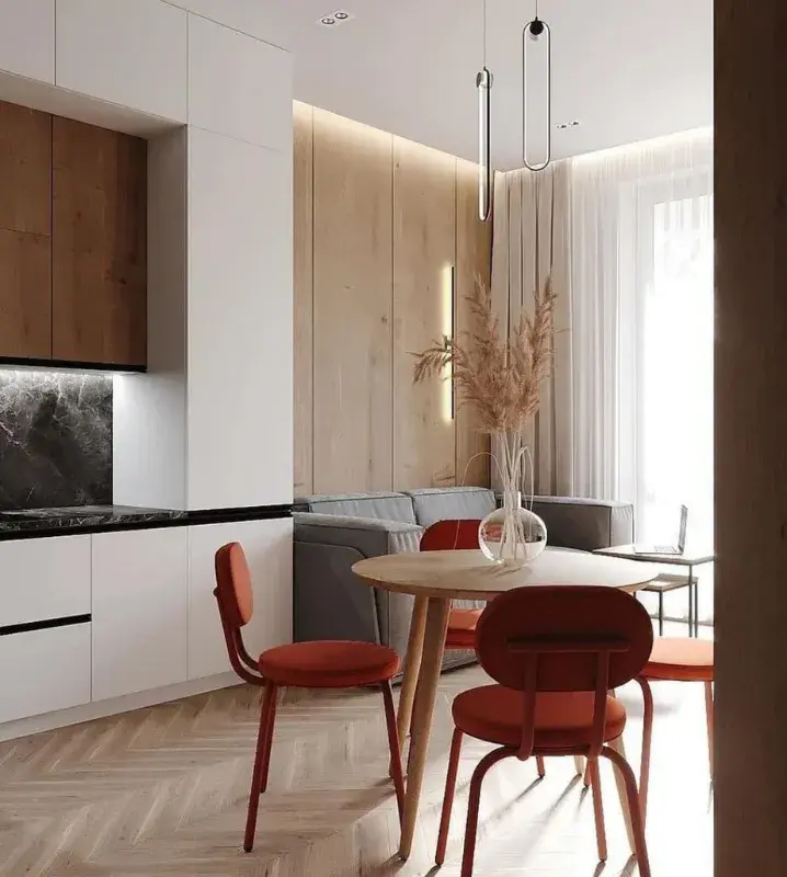 Дизайн кухни-гостиной с диваном и столом