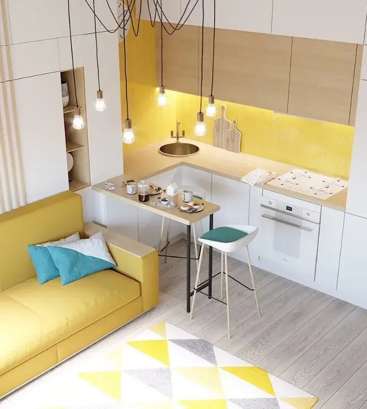 светлая кухня с желтым диваном и барным столом в гостиной