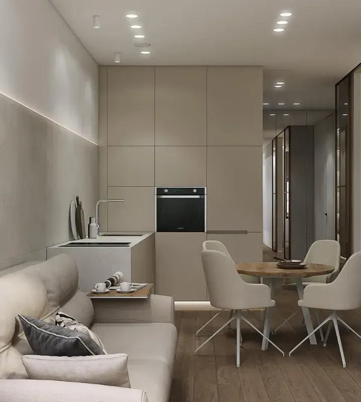серый диван в интерьере кухни-гостиной и светлые тона